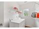 A bright laundry room with white appliances, shelving, and a window at 6397 Autumn View Nw Trce, Acworth, GA 30101