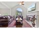 Cozy living room with a fireplace, hardwood floors, and a large arched window at 6397 Autumn View Nw Trce, Acworth, GA 30101