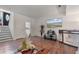 A living room with hardwood floors, staircase, and a wall-mounted television at 6397 Autumn View Nw Trce, Acworth, GA 30101