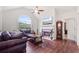 Bright living room featuring hardwood floors, a fireplace, and a large arched window at 6397 Autumn View Nw Trce, Acworth, GA 30101