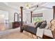 Spacious main bedroom featuring a tray ceiling, canopy bed, and neutral decor at 6397 Autumn View Nw Trce, Acworth, GA 30101