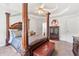 Spacious main bedroom featuring a tray ceiling, canopy bed, and neutral decor at 6397 Autumn View Nw Trce, Acworth, GA 30101