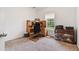 A well-lit office with a large wooden desk, carpeted floors, and window views at 6397 Autumn View Nw Trce, Acworth, GA 30101