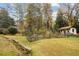 Spacious backyard featuring a lush garden, and a shed, with a distant view of the home at 769 Hampton Sw Pl, Marietta, GA 30064