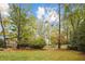 Lush backyard showcasing mature trees and well-maintained lawn at 769 Hampton Sw Pl, Marietta, GA 30064