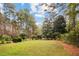 Serene backyard with a large lawn and tall trees, creating a park-like setting at 769 Hampton Sw Pl, Marietta, GA 30064