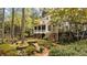 Charming backyard with covered porch, brick accents, and serene water feature at 769 Hampton Sw Pl, Marietta, GA 30064