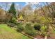 Well-manicured backyard with raised garden beds and a shed, set amidst lush landscaping and mature trees at 769 Hampton Sw Pl, Marietta, GA 30064