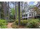 Beautiful backyard view of a large two story home with a porch, surrounded by mature trees and landscaping at 769 Hampton Sw Pl, Marietta, GA 30064