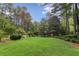Spacious backyard featuring a large lawn area surrounded by trees and landscaping at 769 Hampton Sw Pl, Marietta, GA 30064