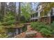 Backyard featuring a tranquil pond and a bench surrounded by lush landscaping and mature trees at 769 Hampton Sw Pl, Marietta, GA 30064