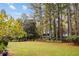 Large backyard with tall trees and lush green lawn offers serene views of the home's back porch at 769 Hampton Sw Pl, Marietta, GA 30064