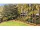 Spacious backyard with mature trees, landscaped garden beds and distant view of home at 769 Hampton Sw Pl, Marietta, GA 30064