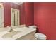 Stylish half bathroom featuring designer wallpaper and vanity at 769 Hampton Sw Pl, Marietta, GA 30064
