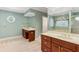 Bathroom featuring wood cabinets, double sinks, and a separate area for soaking tub and walk in shower at 769 Hampton Sw Pl, Marietta, GA 30064