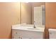 Bathroom featuring single sink vanity, mirror, and wallpaper at 769 Hampton Sw Pl, Marietta, GA 30064