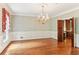 Elegant dining room with hardwood floors, ornate chandelier, chair rail, and floral wallpaper at 769 Hampton Sw Pl, Marietta, GA 30064