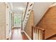Hallway with wood floors, textured wallpaper and a staircase leading to upper floors at 769 Hampton Sw Pl, Marietta, GA 30064