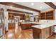 Spacious eat-in kitchen boasts wood beam ceilings, wooden cabinets, hardwood floors, and stainless appliances at 769 Hampton Sw Pl, Marietta, GA 30064