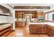 Large eat-in kitchen with wooden cabinets, a white tile backsplash, stainless appliances and hardwood floors at 769 Hampton Sw Pl, Marietta, GA 30064