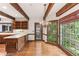 Eat-in kitchen featuring hardwood floors, wood beam ceilings, wooden cabinets, and a large window view at 769 Hampton Sw Pl, Marietta, GA 30064