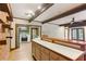 Open kitchen featuring stainless steel appliances, brick wall and exposed beams at 769 Hampton Sw Pl, Marietta, GA 30064