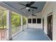 Covered porch features blue painted floors and ceiling, and dual ceiling fans and forest views at 769 Hampton Sw Pl, Marietta, GA 30064