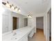 Spacious bathroom features a double sink vanity with granite countertop, tile floor, and decorative light fixtures at 104 Highlands Ridge Se # 1, Smyrna, GA 30082