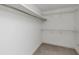 Walk-in closet features carpeted floor, simple shelving, and bright white walls at 104 Highlands Ridge Se # 1, Smyrna, GA 30082