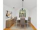 Dining room with wood floors, contemporary lighting and large window overlooking the landscaped yard at 104 Highlands Ridge Se # 1, Smyrna, GA 30082