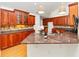 Kitchen with wood floors, wood cabinets, granite countertops, stainless sink and fixtures and under cabinet lighting at 104 Highlands Ridge Se # 1, Smyrna, GA 30082