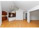 Open-concept kitchen with wood floors, dark wood cabinets, stainless appliances, granite countertops and a breakfast bar at 104 Highlands Ridge Se # 1, Smyrna, GA 30082
