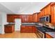 Well-lit kitchen features wood cabinets, granite countertops, a gas range, and stainless steel microwave at 104 Highlands Ridge Se # 1, Smyrna, GA 30082