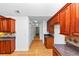 Kitchen showcases wood cabinets, granite countertops, hardwood floors, and easy access to other rooms at 104 Highlands Ridge Se # 1, Smyrna, GA 30082