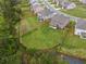 A backyard with a wooden privacy fence surrounds a lush green lawn and a garden in the corner at 2091 Landsburg Way, Lawrenceville, GA 30043
