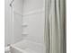 Clean bathroom with a shower-tub combo and a neutral-colored shower curtain at 2091 Landsburg Way, Lawrenceville, GA 30043