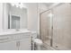 Bright bathroom boasts a glass-enclosed shower, white vanity, and modern fixtures at 2091 Landsburg Way, Lawrenceville, GA 30043