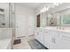 Bathroom with double sink vanity, modern lighting, and glass shower at 2091 Landsburg Way, Lawrenceville, GA 30043