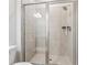 Modern tiled shower with sliding glass doors, overhead shower and a built-in seat at 2091 Landsburg Way, Lawrenceville, GA 30043
