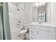 Bright bathroom with a shower and bath combination, toilet and vanity with mirror at 2091 Landsburg Way, Lawrenceville, GA 30043