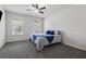 Cozy bedroom with large windows, ceiling fan, neutral carpet and modern decor at 2091 Landsburg Way, Lawrenceville, GA 30043