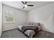 Neutral bedroom featuring a bed with grey linens and a window allowing natural light at 2091 Landsburg Way, Lawrenceville, GA 30043