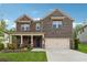 Charming two-story brick and stone home with a well-manicured lawn and attached two-car garage at 2091 Landsburg Way, Lawrenceville, GA 30043