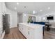 Bright kitchen features white cabinets, stainless steel appliances, and a large center island with seating at 2091 Landsburg Way, Lawrenceville, GA 30043