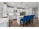 Contemporary kitchen with white cabinetry, stainless steel appliances, and a stylish center island with chairs at 2091 Landsburg Way, Lawrenceville, GA 30043