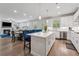 Spacious kitchen open to living area, featuring stainless appliances and ample counter space with bar seating at 2091 Landsburg Way, Lawrenceville, GA 30043