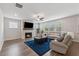 Inviting living room featuring a fireplace, hardwood floors, and ample natural light at 2091 Landsburg Way, Lawrenceville, GA 30043