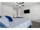 Spacious main bedroom features a ceiling fan, natural light and modern decor at 2091 Landsburg Way, Lawrenceville, GA 30043