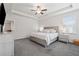 Bright main bedroom with large bed, tray ceiling with ceiling fan, large windows and bedside tables at 2091 Landsburg Way, Lawrenceville, GA 30043