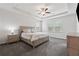 Bright main bedroom features large bed, tray ceiling with ceiling fan, and two windows at 2091 Landsburg Way, Lawrenceville, GA 30043